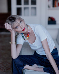Soho gold necklace styled on model's neck with 18k yellow gold 1885 grande links bracelet