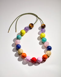 Noho downtown necklace including Tiger's eye, Amethyst, Amazonite, Rose quartz and Lapis lazuli semi precious spheres, with lemon, terracotta, flamingo and big apple red enamel spheres, 18k yellow gold florentine finish spheres