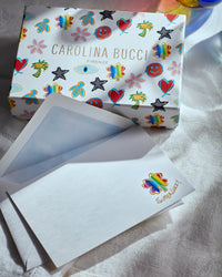 Pineider lucky stationary kit on white fabric background
