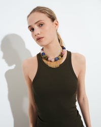 Carolina Bucci Alphabet City Downtown Necklace, Woven Fringe with beaded semi-precious stones (unakite, tiger's eye, rhodonite, rose quartz, lapis lazuli), 18k yellow gold chain, worn by model, lifestyle setting