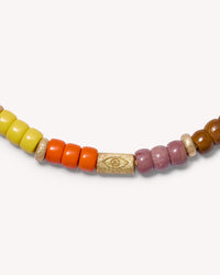 Close-up, Florentine finish evil eye bead, 2 Florentine finish 18k yellow gold bead and hard stoned beads