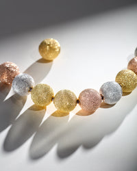 18k yellow, white and rose gold florentine frosted finish spheres on white background