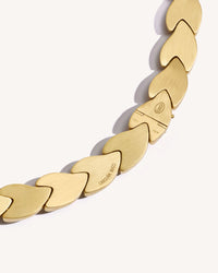 Close-up, back view of EveryDay necklace clasp, brushed 18k yellow gold, engraved logo, on white background