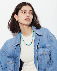 Forte beads careyes necklace with 18k yellow gold tipped sun lurex cord, 80 hard stoned beads, 18k yellow gold flower bead and 10 Florentine finish 18k gold beads modelled around the neck.