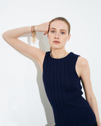 18k yellow gold open beaded choker on model styled with 18k gold lucky bracelet collection