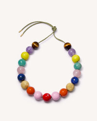 Noho downtown necklace including Tiger's eye, Amethyst, Amazonite, Rose quartz and Lapis lazuli semi precious spheres, with lemon, terracotta, flamingo and big apple red enamel spheres, 18k yellow gold florentine finish spheres