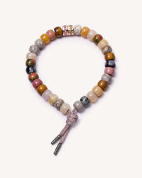 Serengeti Forte beads bracelet with heather pink lurex cord and 18k black gold caps and 18k yellow gold precious bead with champagne diamonds and 18k pink gold precious bead with pink sapphires