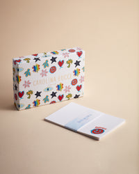 Pineider lucky stationary kit on cream background