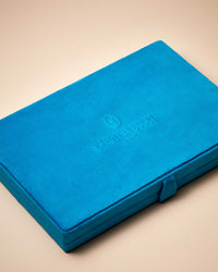 Closed Blue velvet earring case engraved with Carolina Bucci logo