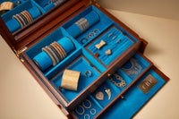 Pineider jewellery box showcasing Kiss bracelets, cuff bracelets cuore, thick and tutto per te rings, multi wish lazy lucky bracelet, pavé cuore pendant, florentine finish corno pendant, 1885 links necklace and fringe necklace